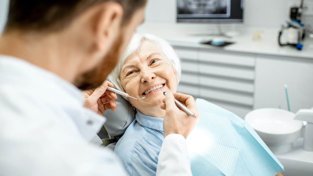 Dentist with an older adult female patient